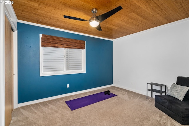 sitting room with a ceiling fan, wooden ceiling, carpet, and baseboards