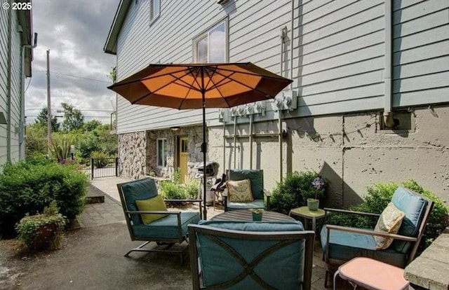 view of patio featuring outdoor lounge area and fence