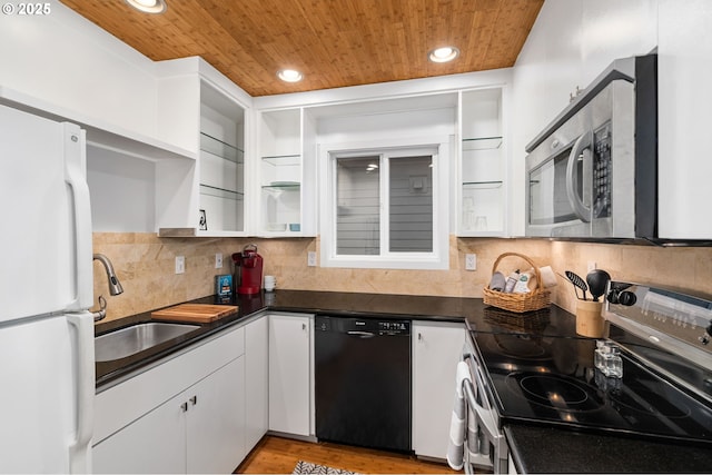 kitchen featuring a sink, white cabinets, wood ceiling, appliances with stainless steel finishes, and dark countertops