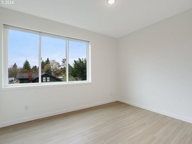 spare room with light hardwood / wood-style floors