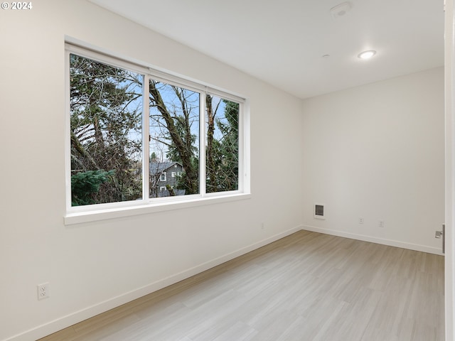 spare room featuring light hardwood / wood-style flooring