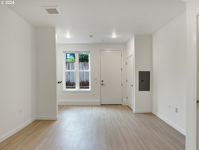 interior space with light wood-type flooring and electric panel