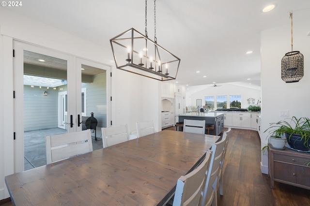 dining room with ceiling fan, lofted ceiling, and dark hardwood / wood-style flooring