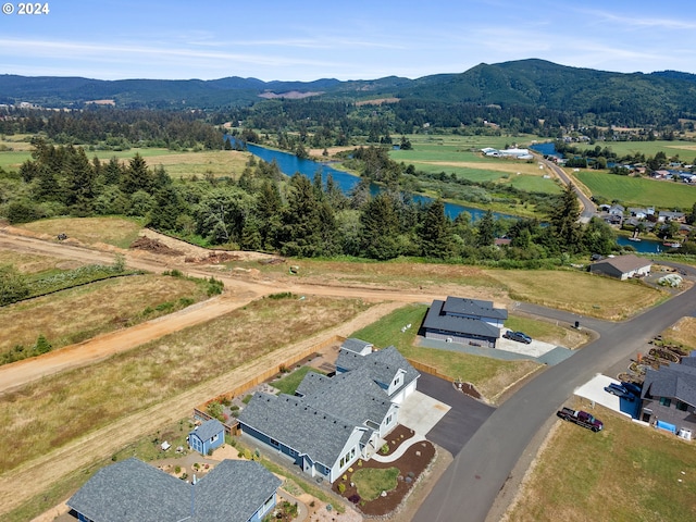 drone / aerial view featuring a water and mountain view