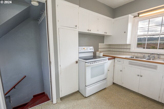 kitchen featuring decorative backsplash, white cabinetry, white range with electric stovetop, and sink