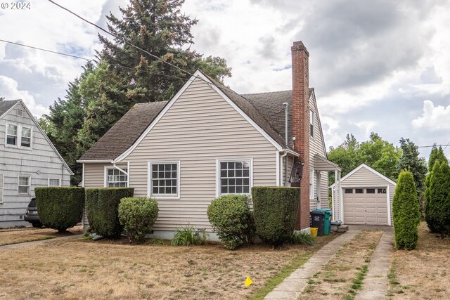 view of property exterior featuring a garage and an outdoor structure