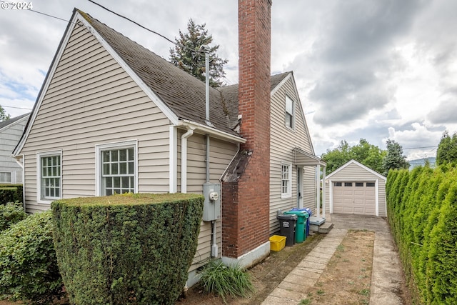 view of side of property with an outdoor structure and a garage