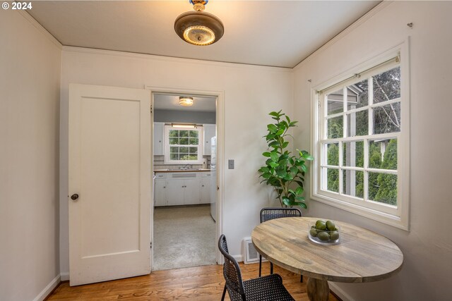 dining room featuring crown molding and hardwood / wood-style flooring