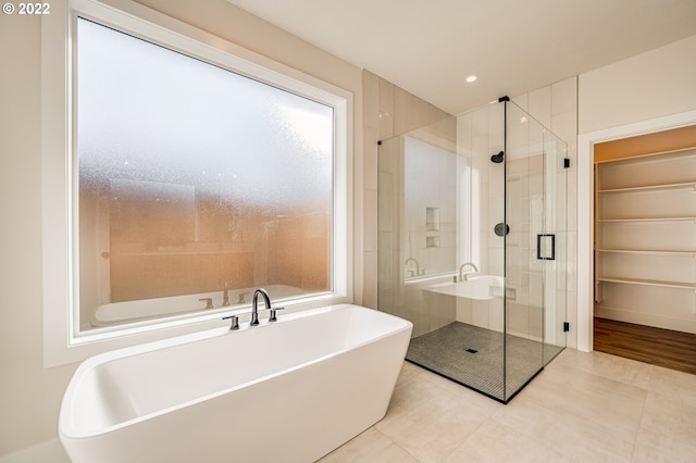 bathroom featuring shower with separate bathtub and tile patterned floors