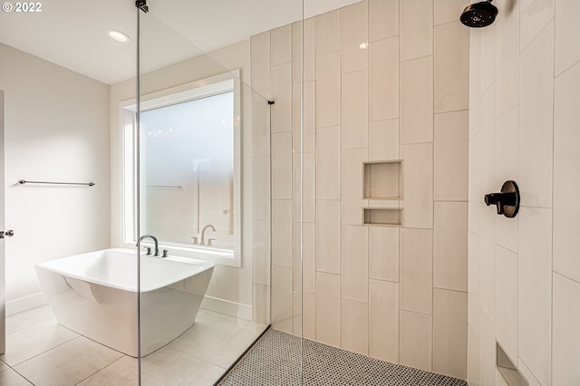 bathroom featuring tile patterned flooring and separate shower and tub