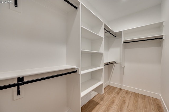 spacious closet with light hardwood / wood-style floors