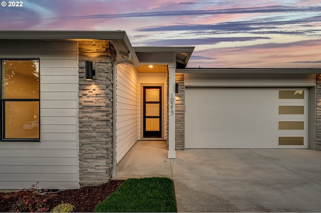 exterior entry at dusk with a garage