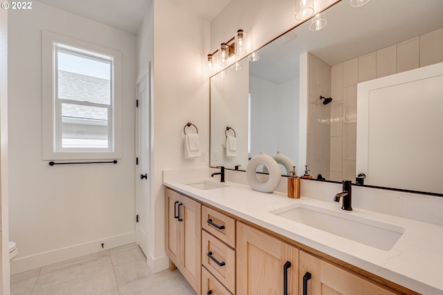 bathroom featuring tile patterned flooring, vanity, and toilet