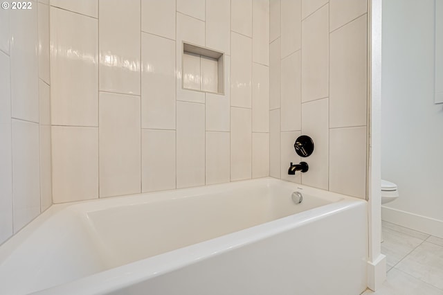 bathroom featuring a bathtub, tile patterned flooring, and toilet