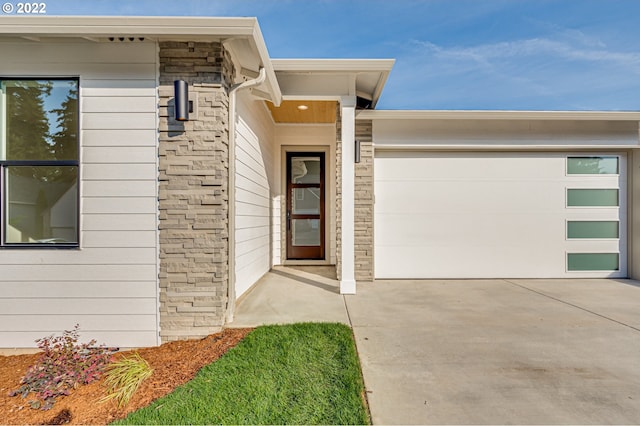 doorway to property with a garage