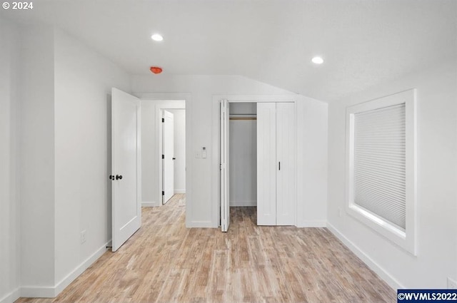 unfurnished bedroom featuring light hardwood / wood-style flooring and a closet