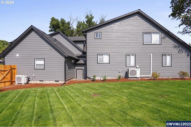 back of property featuring central AC unit, a yard, and ac unit