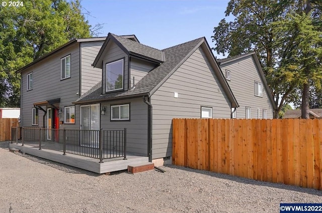 back of house featuring a wooden deck