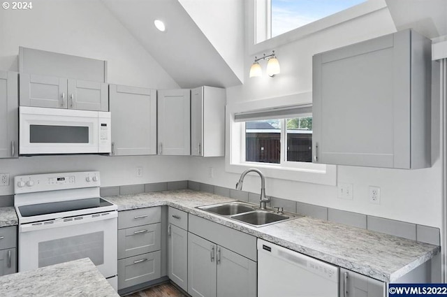 kitchen with sink, white appliances, and gray cabinetry