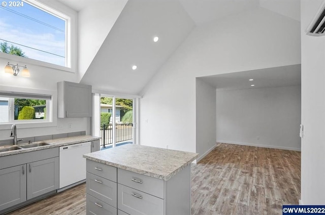 kitchen with gray cabinets, sink, white dishwasher, and high vaulted ceiling