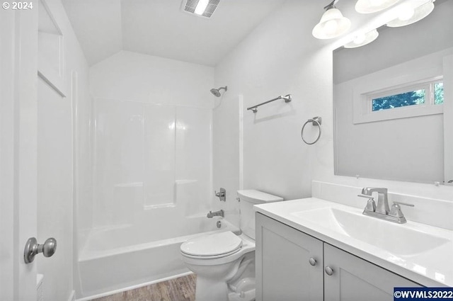 full bathroom featuring lofted ceiling, toilet, hardwood / wood-style floors, vanity, and bathtub / shower combination