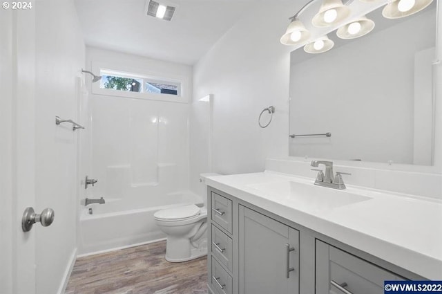 full bathroom featuring hardwood / wood-style floors, vanity, toilet, and shower / bath combination