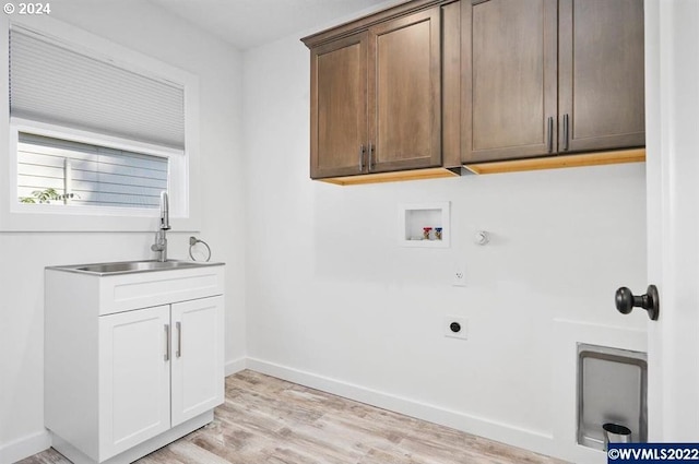 laundry room with electric dryer hookup, cabinets, sink, washer hookup, and light wood-type flooring