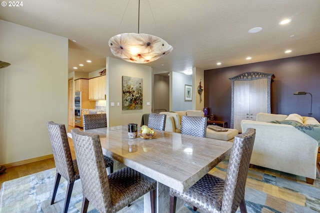 dining area featuring light wood-style floors, recessed lighting, and baseboards