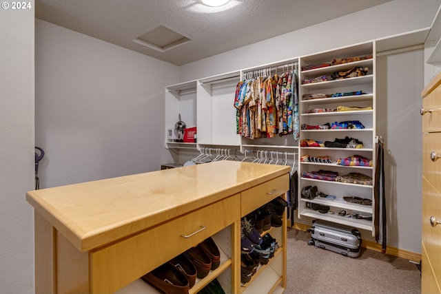 spacious closet featuring carpet flooring and attic access