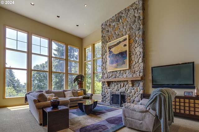 carpeted living room with a fireplace, a high ceiling, and recessed lighting