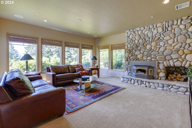 carpeted living area with visible vents, a textured ceiling, and recessed lighting