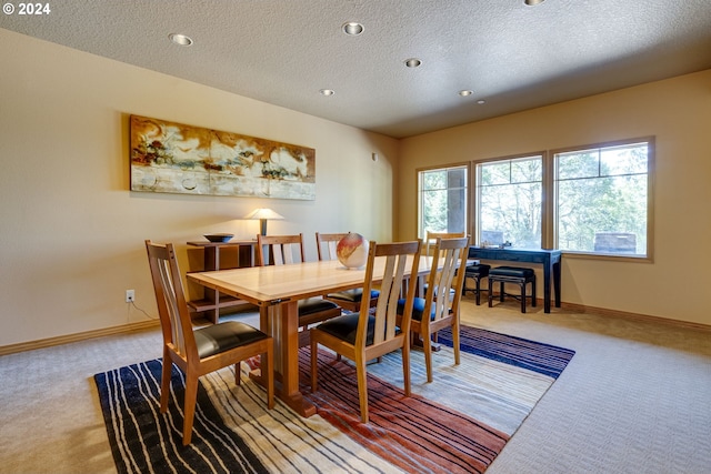 dining room with light carpet, a textured ceiling, recessed lighting, and baseboards