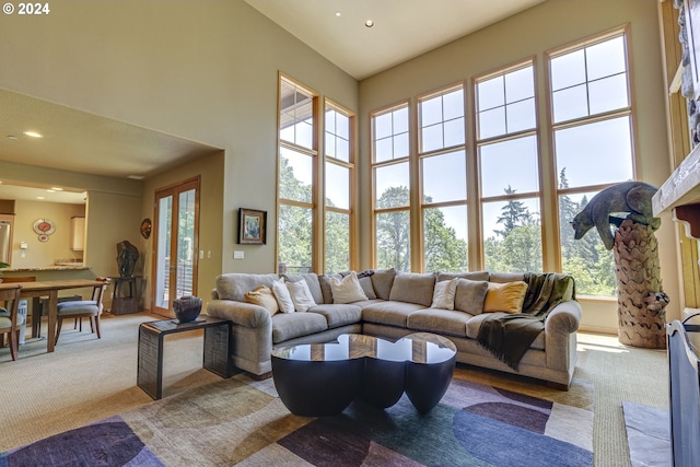 carpeted living room with a towering ceiling and recessed lighting