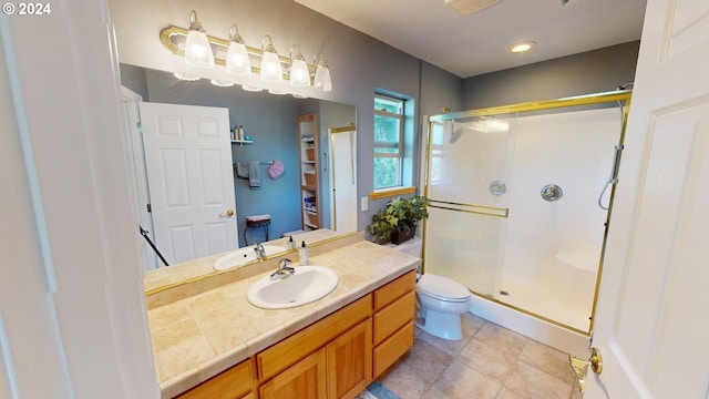 bathroom featuring tile patterned floors, a stall shower, toilet, and vanity