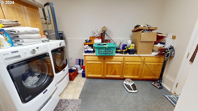 clothes washing area with cabinet space and washing machine and dryer