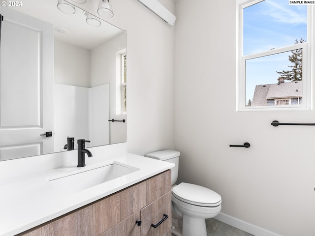 bathroom with vanity, tile flooring, and toilet