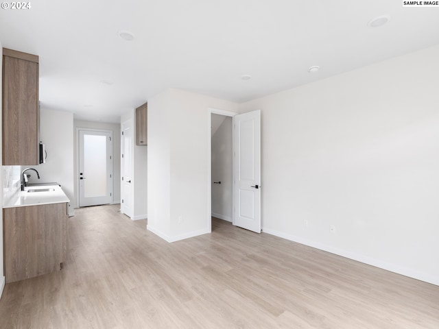 kitchen with light wood-type flooring and sink