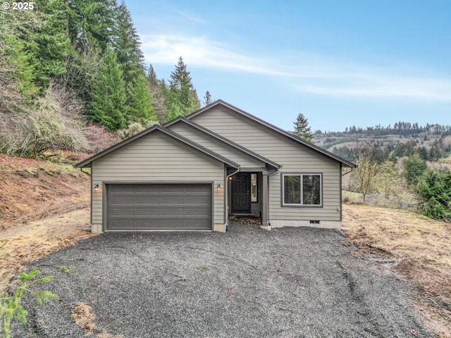 view of front of house with gravel driveway, crawl space, and a garage