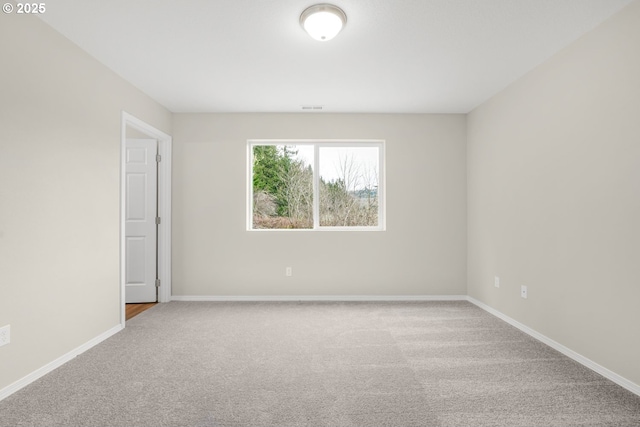 unfurnished room with baseboards, visible vents, and carpet flooring