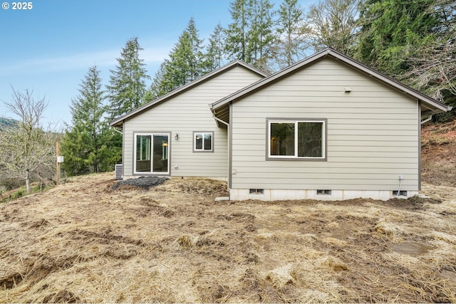 rear view of house featuring crawl space