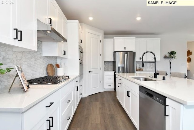 kitchen featuring dark hardwood / wood-style flooring, stainless steel appliances, a kitchen island with sink, sink, and white cabinets