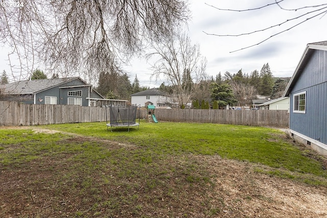 view of yard featuring a playground and a trampoline