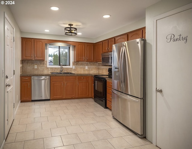 kitchen with tasteful backsplash, sink, and stainless steel appliances