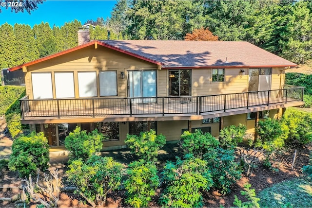 back of property featuring a wooden deck