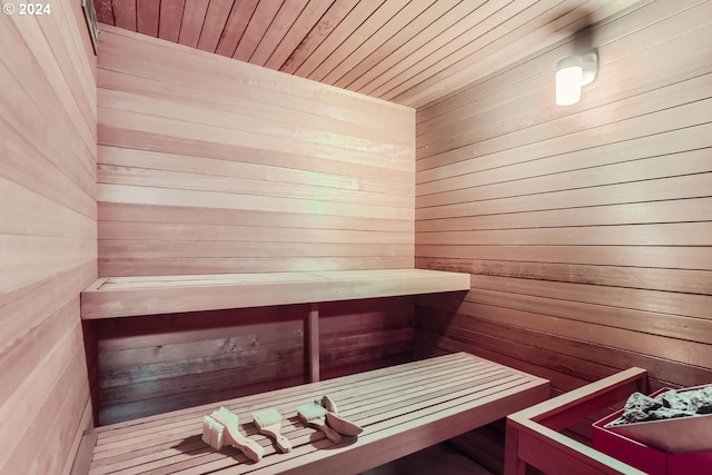 view of sauna with wood walls and wood ceiling