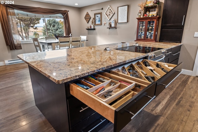 kitchen featuring light stone countertops, baseboards, dark wood-type flooring, recessed lighting, and a baseboard heating unit