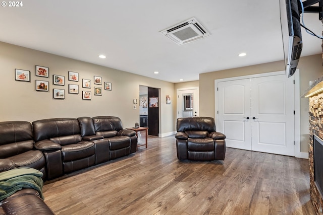 living room with hardwood / wood-style flooring and a fireplace