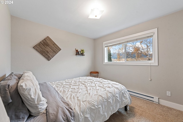 carpeted bedroom with a baseboard heating unit