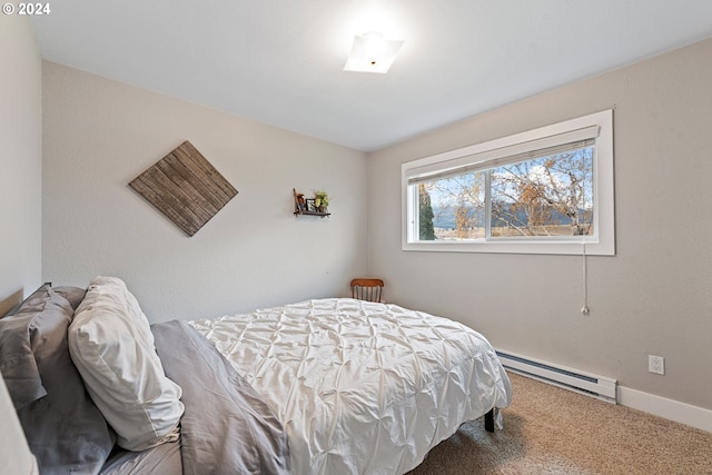 carpeted bedroom featuring a baseboard heating unit