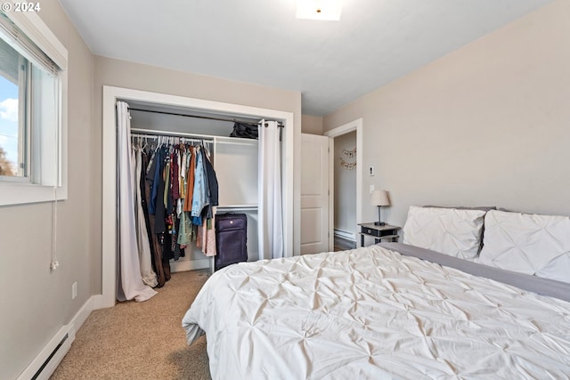 carpeted bedroom featuring a closet and baseboard heating